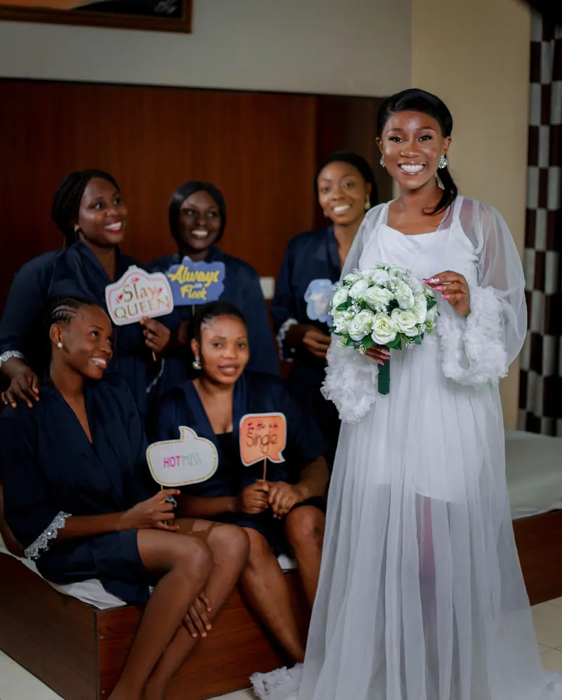 Bride and bridesmaids celebrating a bridal shower with fun props and joy.