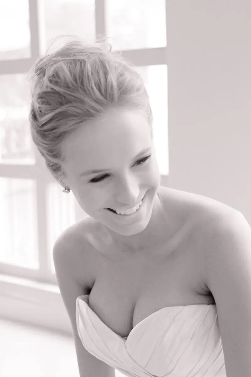 A beautiful bride captured in a soft, elegant portrait with natural light indoors.