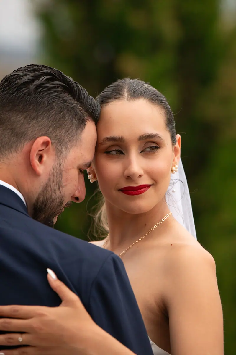 A bride and groom share a tender moment outdoors in Mendoza, Argentina.