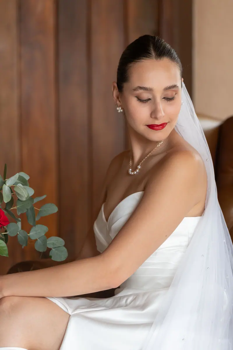 Elegant bridal portrait in a serene setting with wooden backdrop, Mendoza, Argentina.