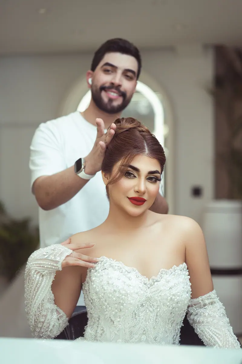 A bride getting her hair styled by a hairstylist indoors, capturing elegance and detail.