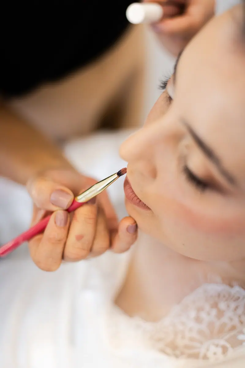 Close-up of a bride having her makeup applied before the wedding in São Paulo.