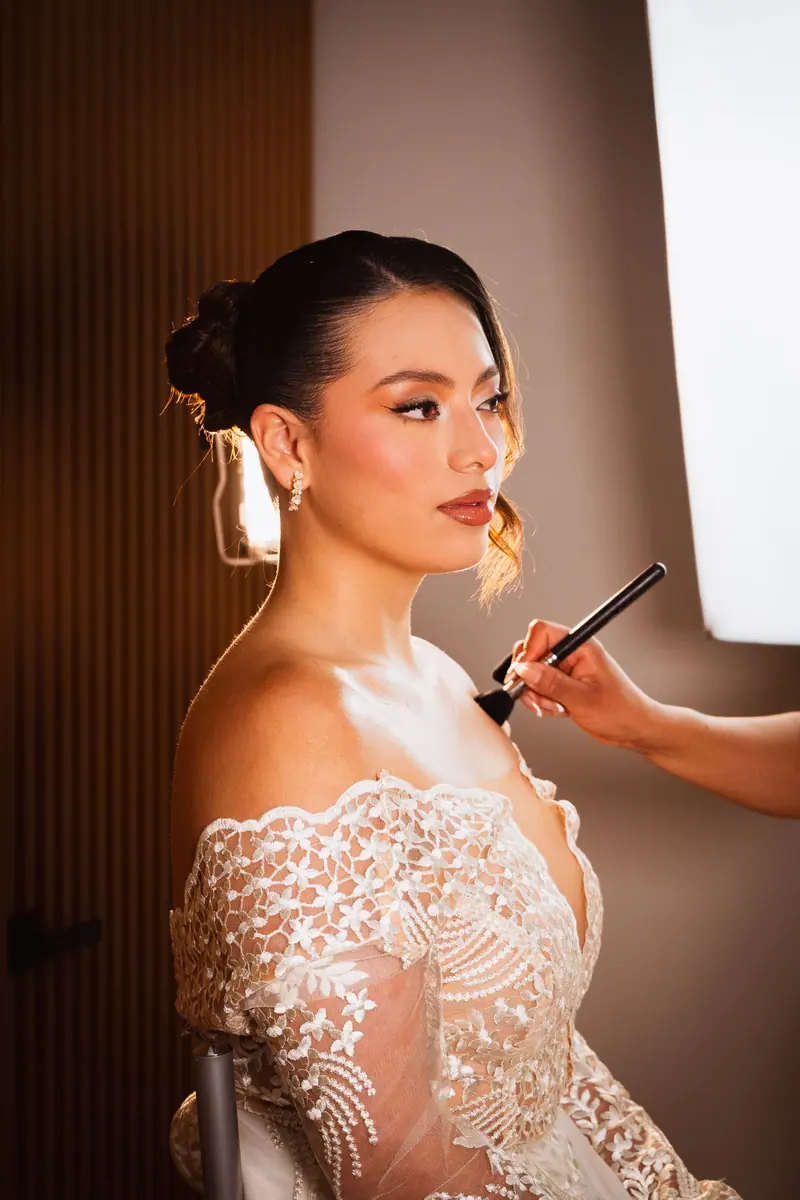 Bride in Mexico City gets makeup applied in preparation for wedding photoshoot.