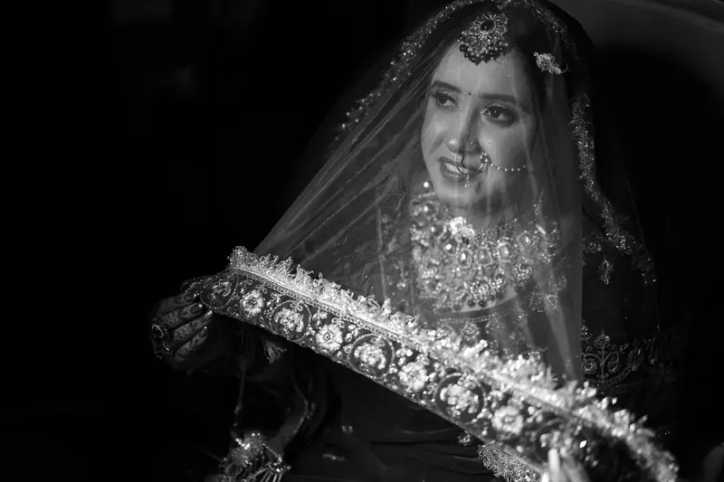 A beautiful Indian bride with intricate jewelry and a veil captures a timeless moment.