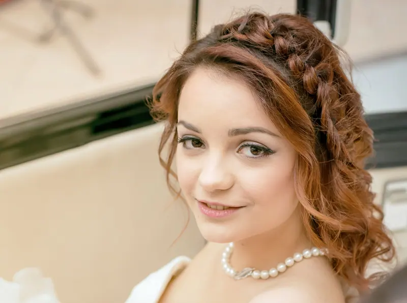 Portrait of a woman with braided hair and a pearl necklace capturing a timeless elegance.