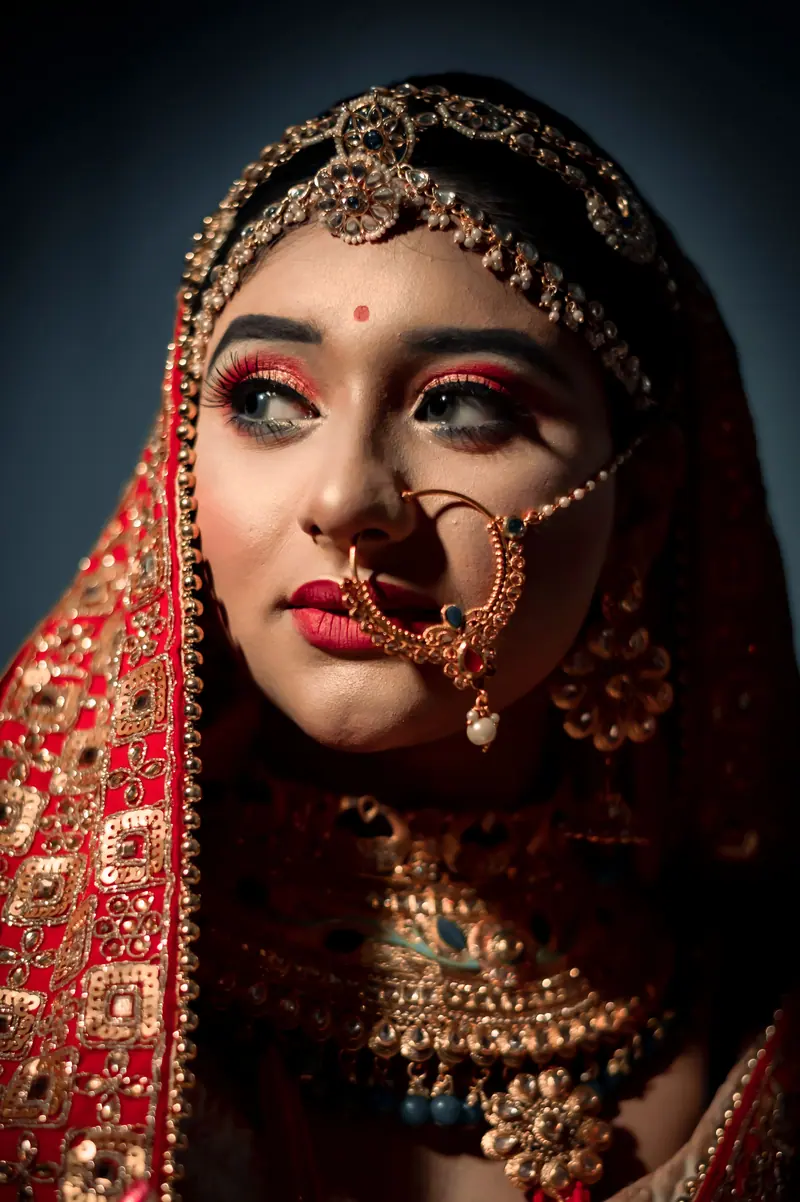 Stunning portrait of an Indian bride in vibrant traditional jewelry and attire.