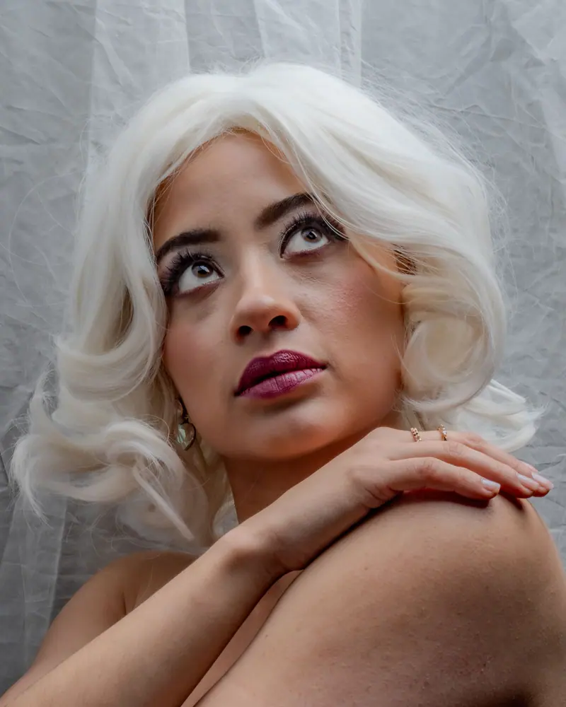 Stunning portrait of a woman with platinum hair against a soft background, showcasing elegance and poise.