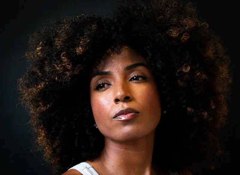 Striking portrait of a woman with afro-textured hair, showcasing empowerment and style.