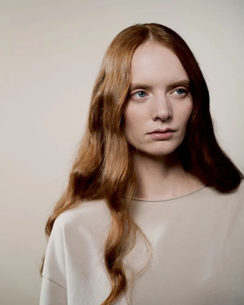 Long copper lengths in a soft studio portrait