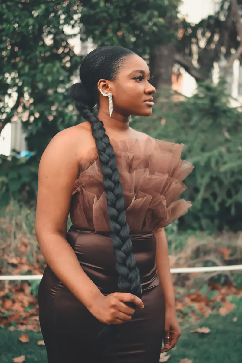 Long braided ponytail extension worn outdoors