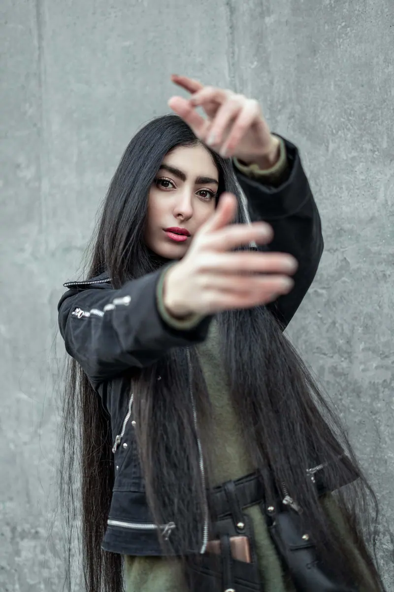 Waist-length black hair in a city street