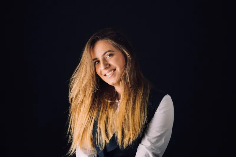 Long caramel waves against black