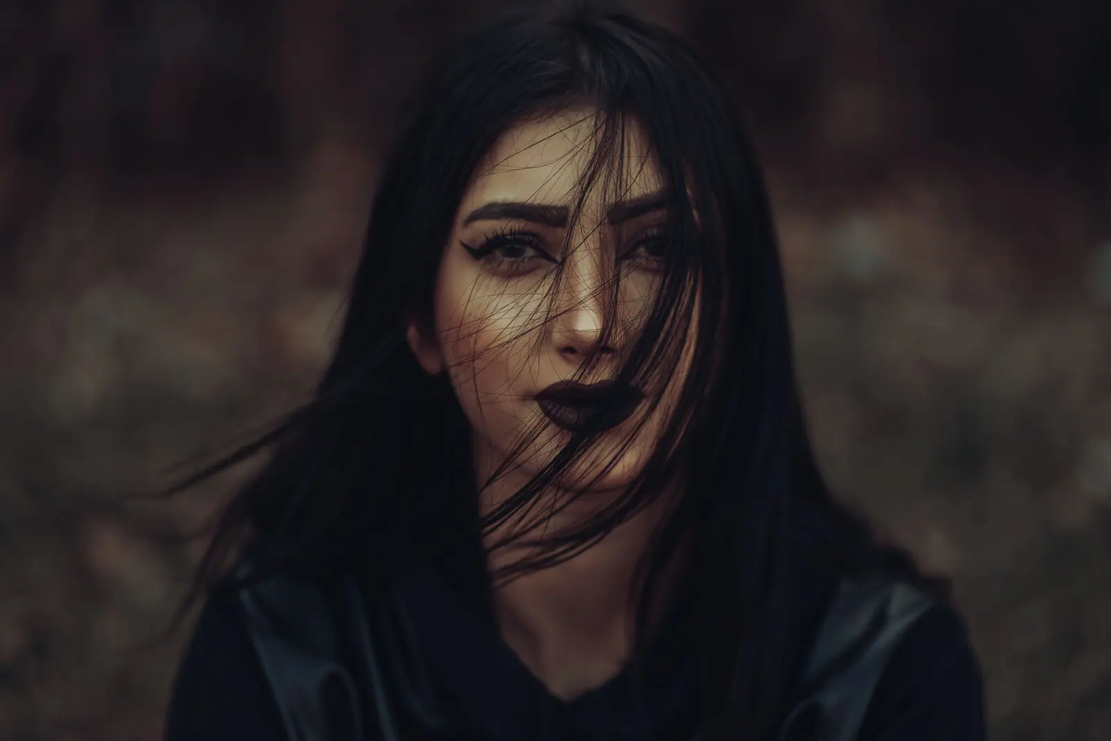 Moody portrait of long dark hair in low light