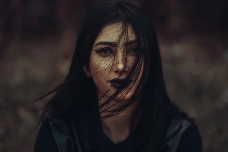 Moody portrait of long dark hair in low light