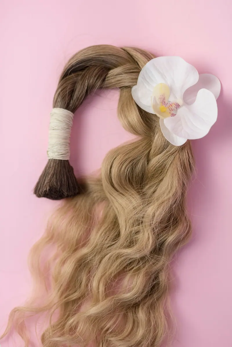 Wavy blonde bundle tied with an orchid