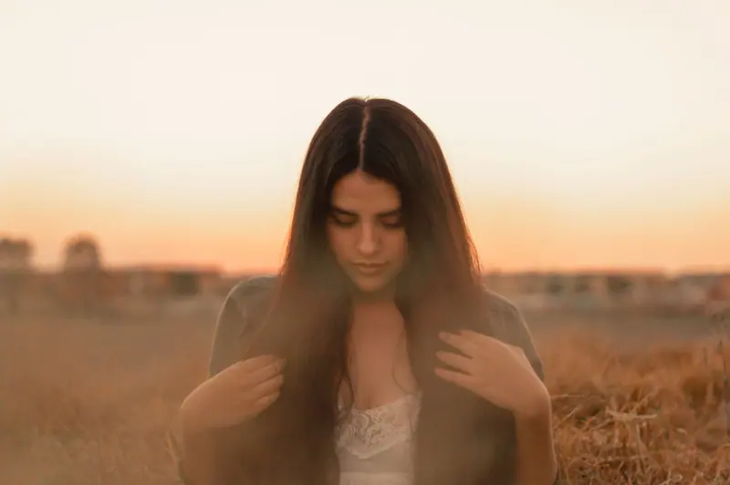 Long dark hair in a golden field