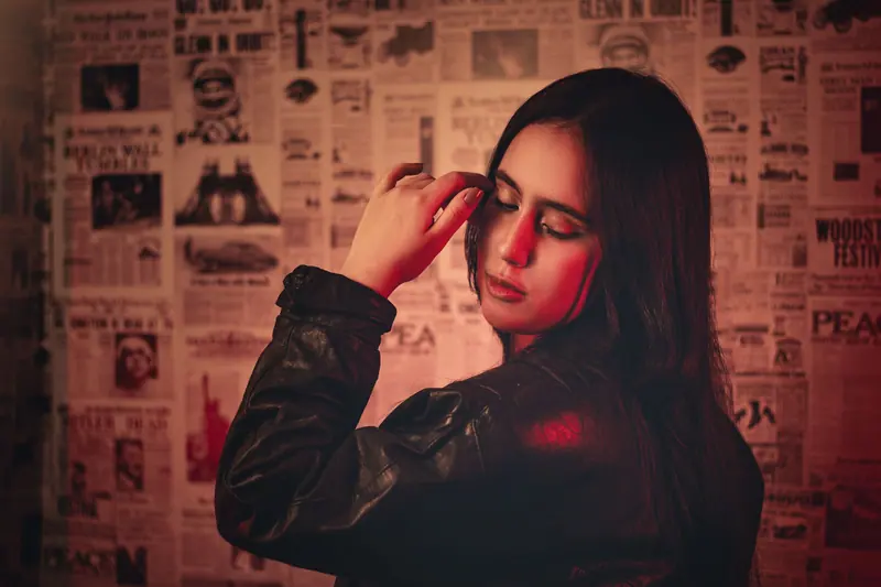 Woman with long dark hair in warm red light