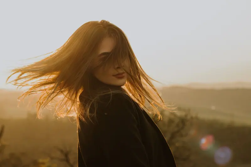 Hair caught in golden-hour wind