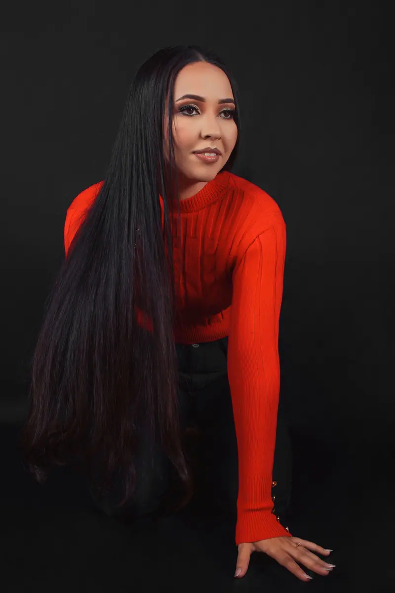 Very long straight black hair with a red sweater