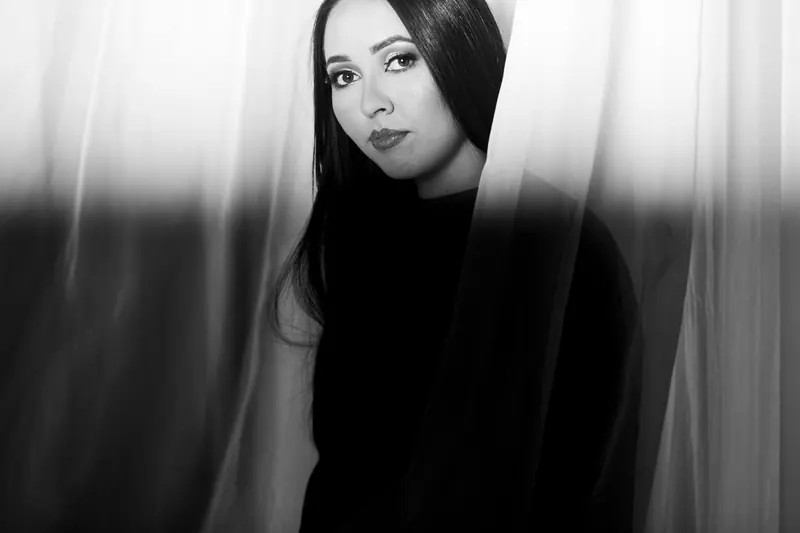 Long dark hair in a black-and-white studio portrait