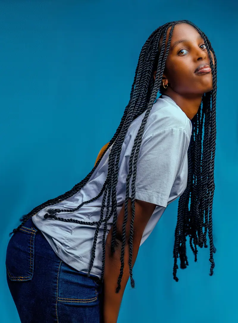 Long braids against turquoise