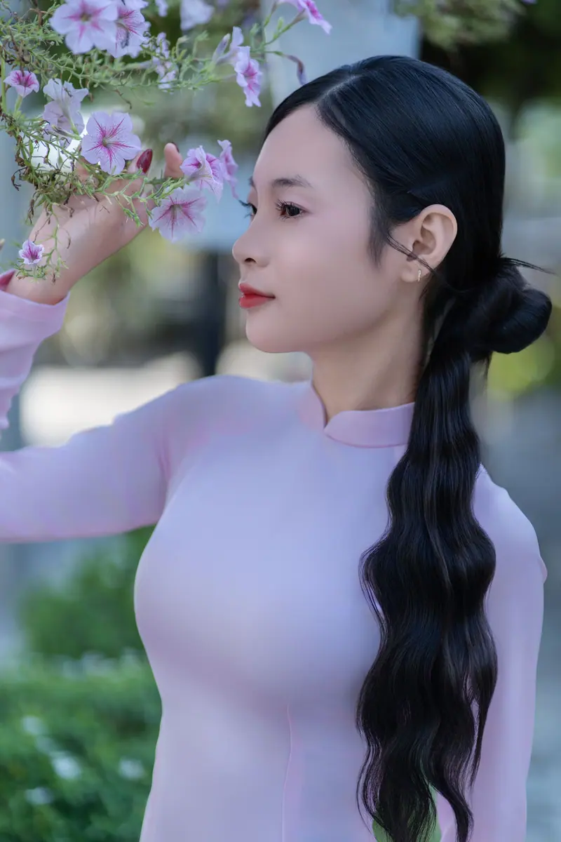 Long dark braid among spring blossoms
