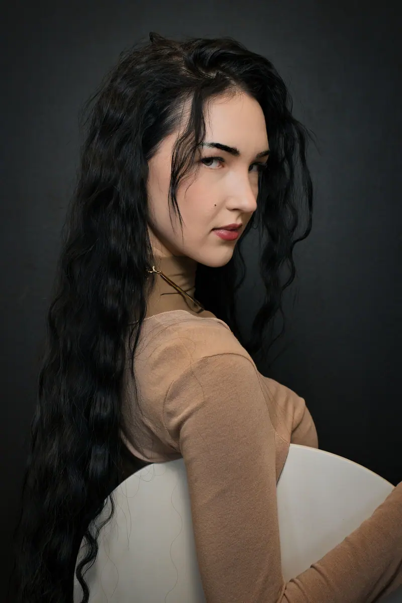 Long dark waves in a softly lit portrait