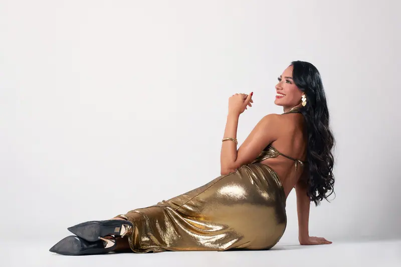 Very long dark hair and a gold gown