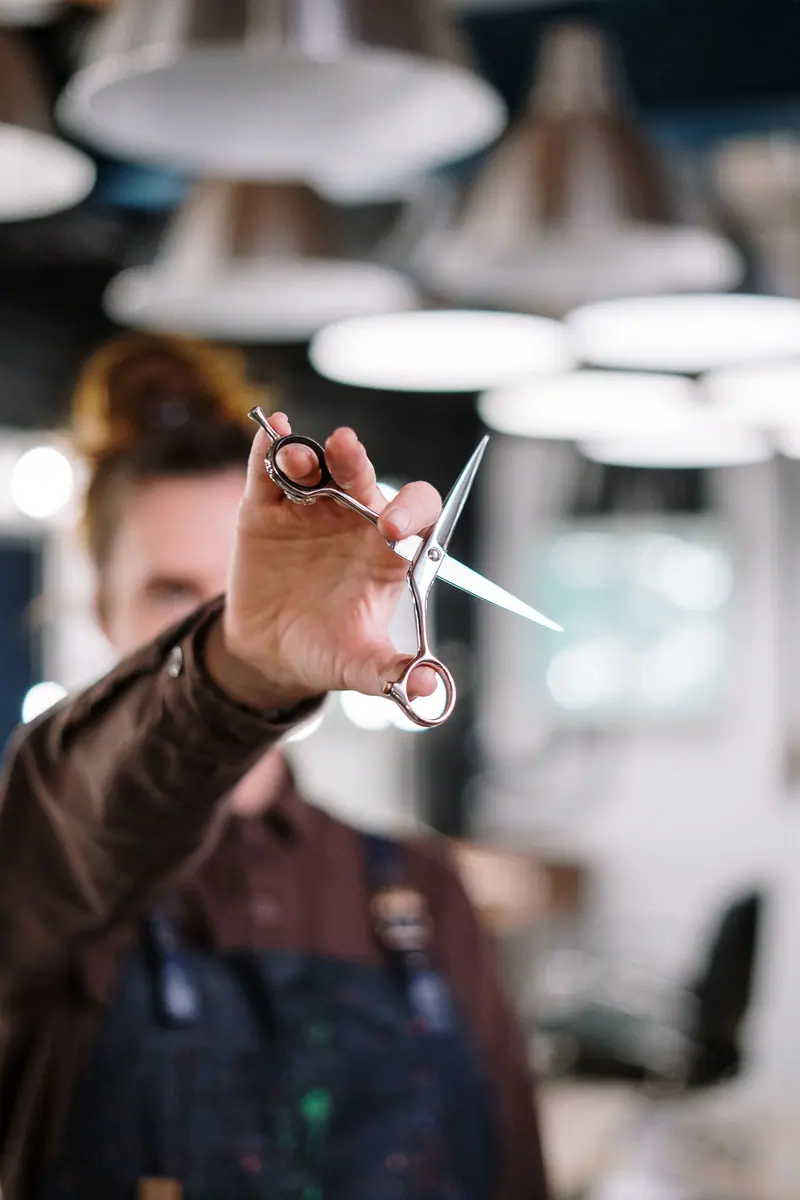 Artist with shears in a bright atelier