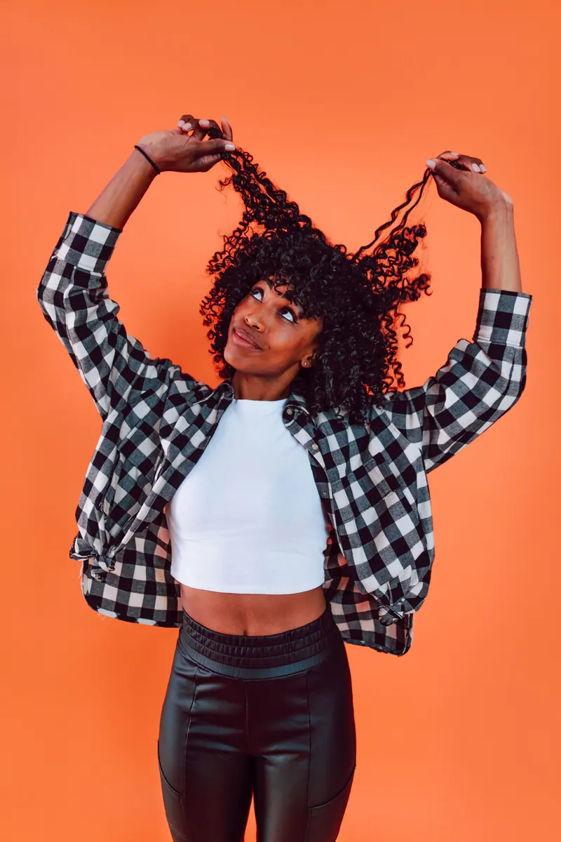 Hair flip against tangerine