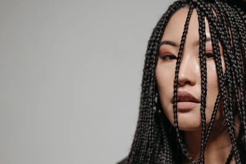 Long braids against grey