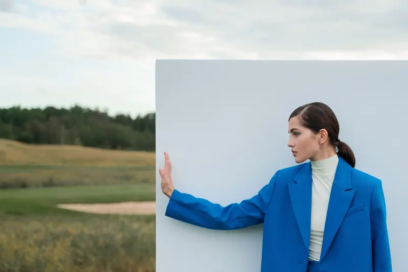 Cobalt jacket against a white panel