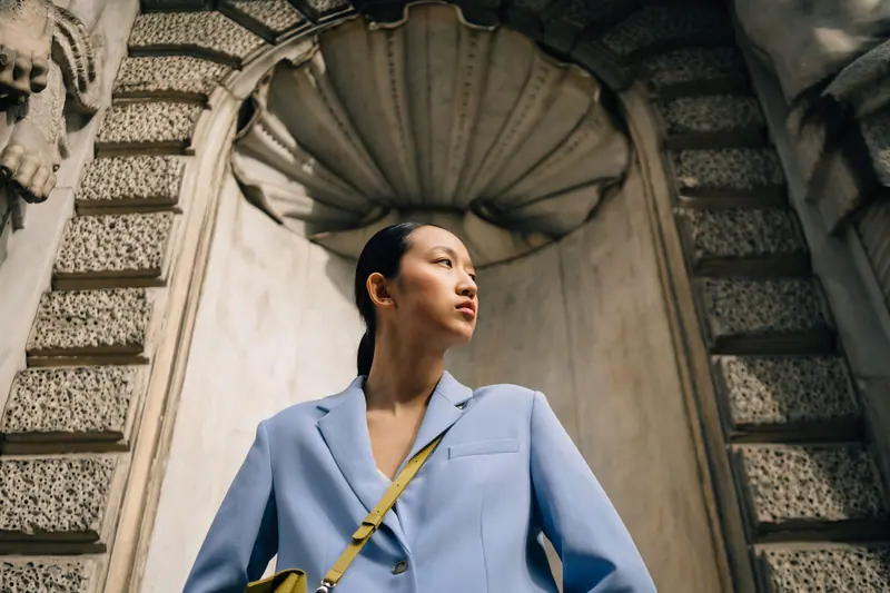 Pale blue suit under a carved shell arch