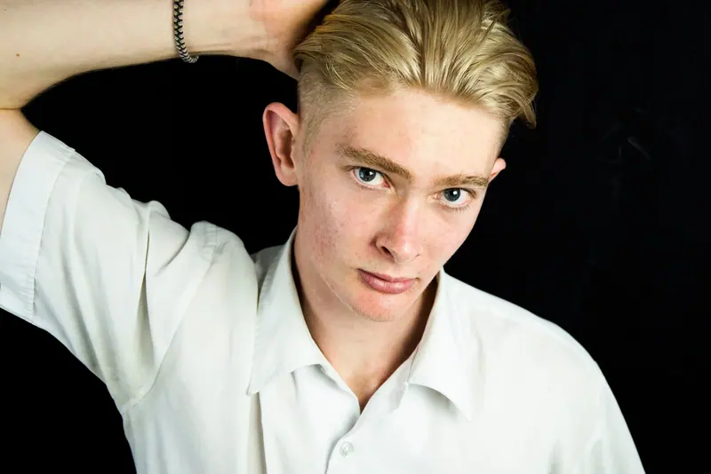 Swept-back blonde against black