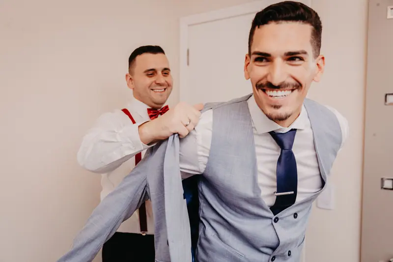 Groomsman fixing a tie