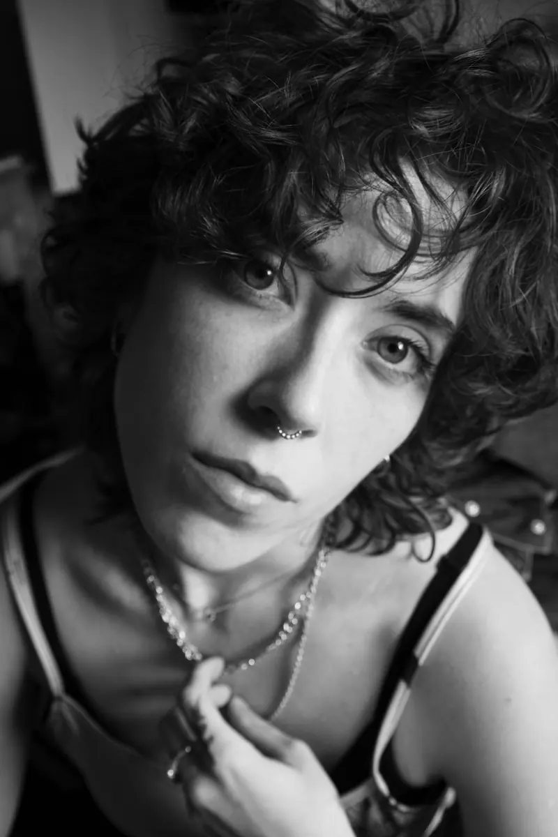 Black and white portrait of short, tousled curls