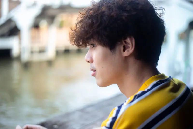 Dark curls by the water