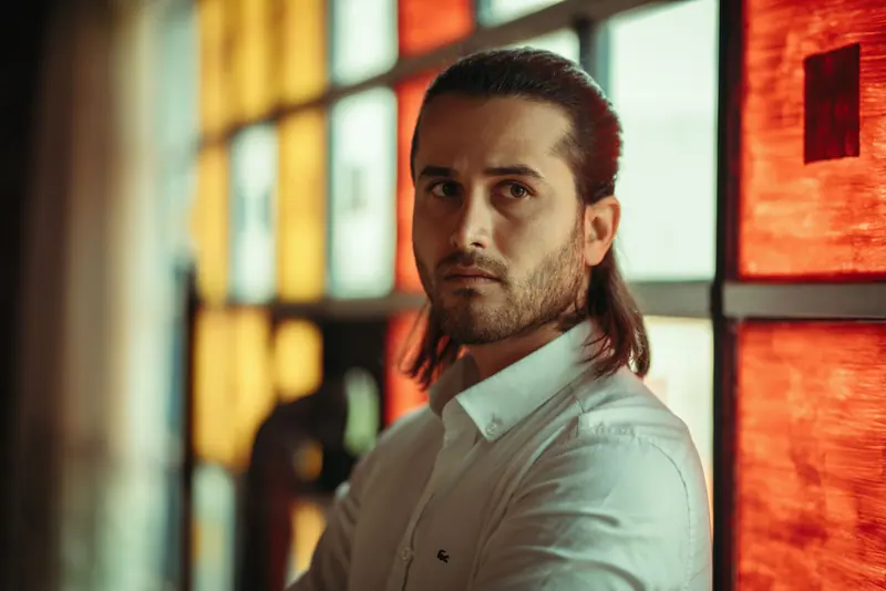 Long hair slicked back with a beard