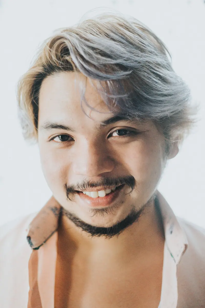 Smiling client with silver-streaked, tousled hair