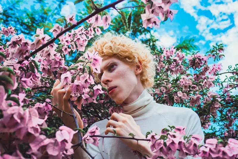 Blond curls among pink blossoms