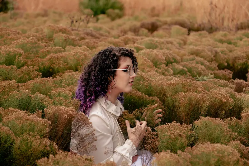 Violet-tipped curls in a field of dried grasses