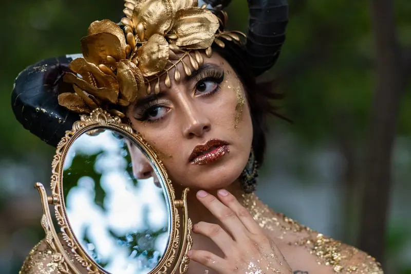 Gold crown and glitter makeup