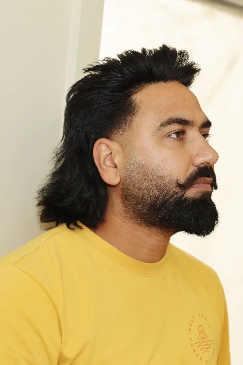 Classic mullet with a full beard in profile