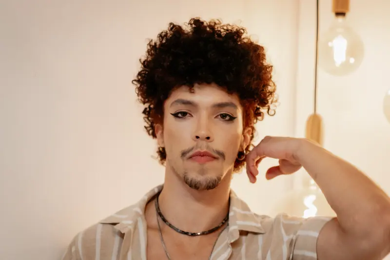 Curly top and a moustache in warm light
