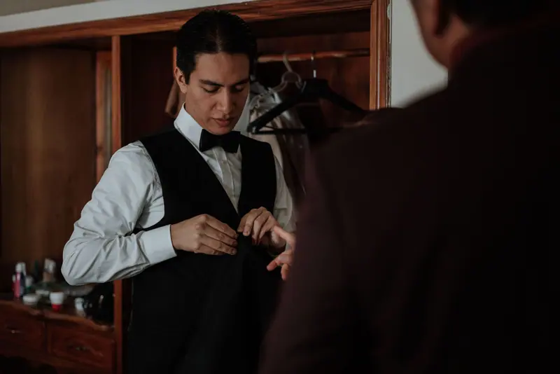 Groom dressing in a waistcoat