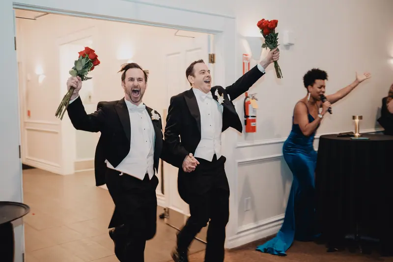 Grooms celebrating with roses