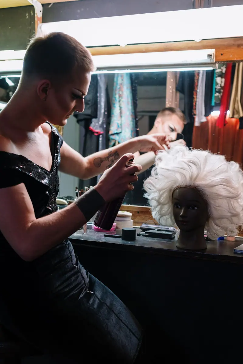 Performer brushing out a wig before the show
