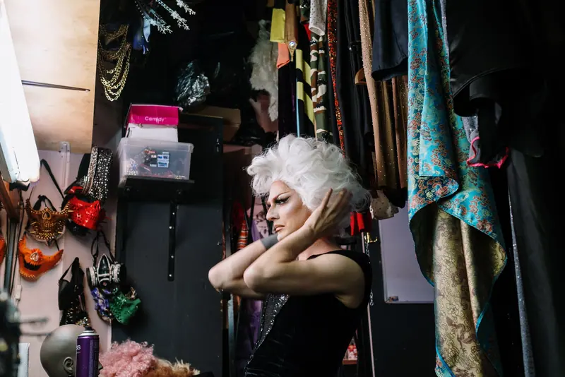 Dressing room with costume racks and wig heads