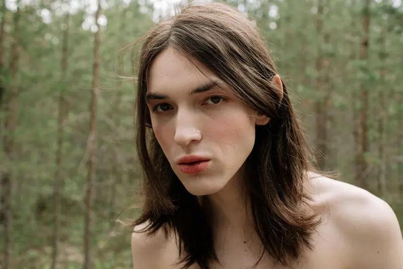 Shoulder-length hair in a pine forest