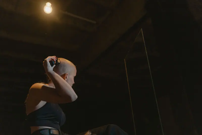 Shaved head in a dark loft